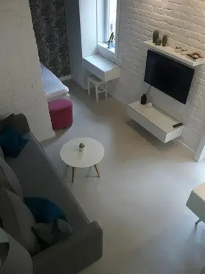 a living room with a couch and a tv at Momo Apartment in Belgrade