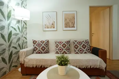 a living room with a couch and a table at Belgrade Sky Apartment in Belgrade