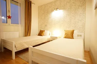 a bedroom with two beds and a window at Belgrade Sky Apartment in Belgrade