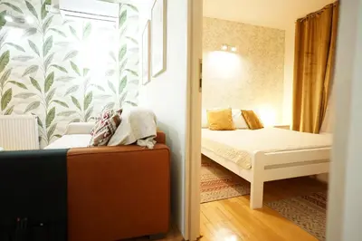 a small bedroom with a bed and a window at Belgrade Sky Apartment in Belgrade