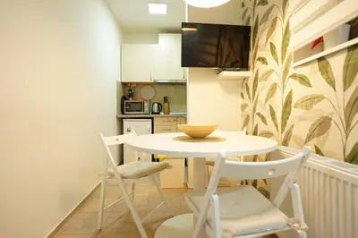 a small kitchen with a white table and chairs at Belgrade Sky Apartment in Belgrade