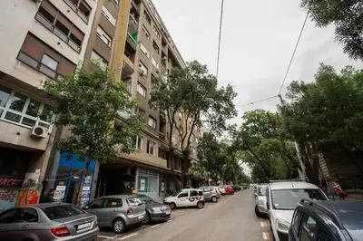 a street with cars parked on the side of a building at Belgrade Sky Apartment in Belgrade