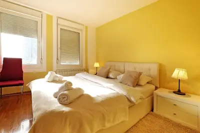 a bedroom with a bed with a stuffed animal on it at Apartment Bella Art in Belgrade