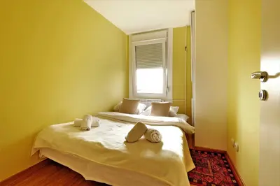 a bedroom with two beds and a window at Apartment Bella Art in Belgrade