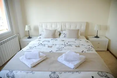 a bedroom with a bed with towels on it at Apartment Bella Art in Belgrade