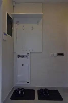 a kitchen with two pairs of shoes on a rug at Apartman Centar Bg in Belgrade