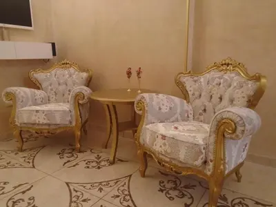 two chairs and a table in a room at Apartment Bourgeois in Belgrade
