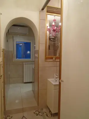 a bathroom with a toilet and a sink and a mirror at Apartment Bourgeois in Belgrade
