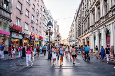 a group of people walking down a busy city street at Apartment Bourgeois in Belgrade