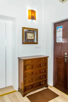a wooden dresser in a room with a door at Prenociste Nikolas Grand in Smederevo