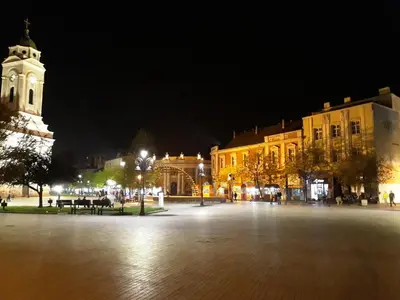 a town square at night with a clock tower at Prenociste Nikolas Grand in Smederevo