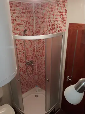 a shower with a glass door in a bathroom at Prenociste Nikolas Grand in Smederevo