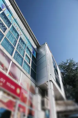 a glass building with a sign in front of it at Happy Star Club in Belgrade