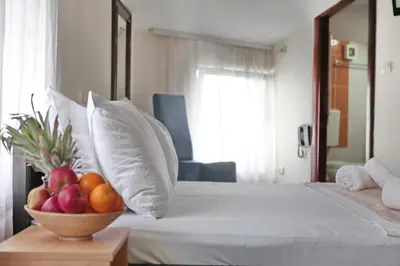 a hotel room with a bowl of fruit on a bed at Happy Star Club in Belgrade
