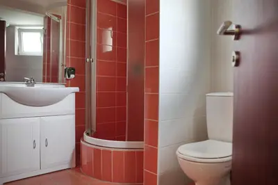 a bathroom with a toilet and a sink and a shower at Happy Star Club in Belgrade