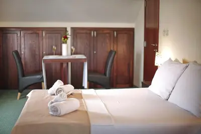a hotel room with a bed with towels on it at Happy Star Club in Belgrade