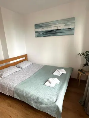 a bedroom with a bed with two towels on it at Bardolino Apartment in Belgrade