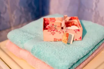two gift boxes sitting on top of a blue towel at Apartment Dorcol in Belgrade