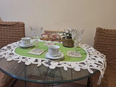 a glass table with cups and saucers on it at Jezero in Arandjelovac