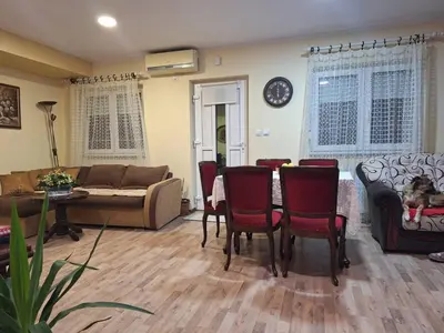 a living room with a couch and a table and chairs at Jezero in Arandjelovac