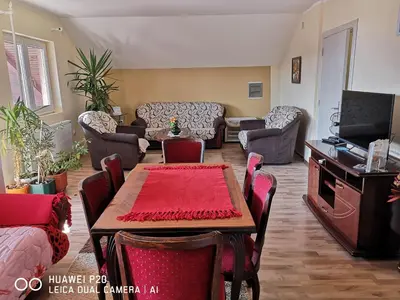 a living room with a table and chairs at Jezero in Arandjelovac