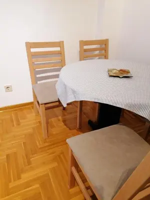 a dining room with two tables and two chairs at Stardust Belgrade in Belgrade