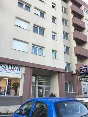 a blue car parked in front of a building at Stardust Belgrade in Belgrade