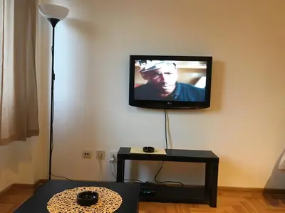 a flat screen tv hanging on a wall in a living room at Stardust Belgrade in Belgrade