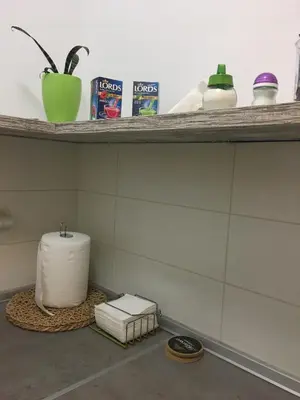 a shelf with a roll of toilet paper on it at Stardust Belgrade in Belgrade