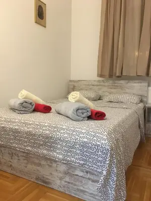 a bedroom with two beds with towels on them at Stardust Belgrade in Belgrade