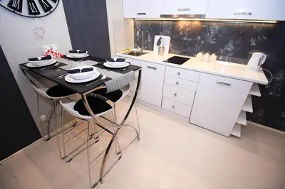 a kitchen with a counter and a island with stools at Apartment Lovac in Belgrade