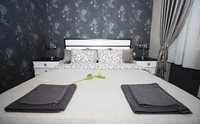 a bedroom with a bed with two towels on it at Apartment Lovac in Belgrade