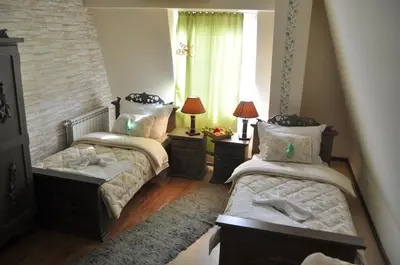 a bedroom with two beds and a window at Vila Hit in Ruma