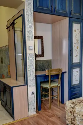 a room with a desk and a chair in a room at Vila Hit in Ruma