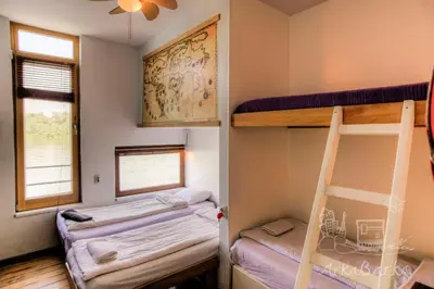 a room with two bunk beds and a window at ArkaBarka Floating Hostel in Belgrade