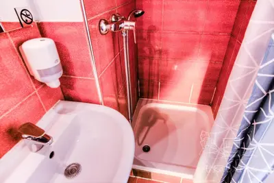 a small bathroom with a toilet and a sink at ArkaBarka Floating Hostel in Belgrade