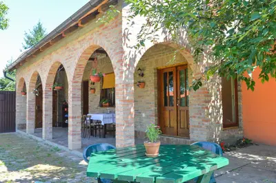 a brick house with a green table in front of it at etno dom 