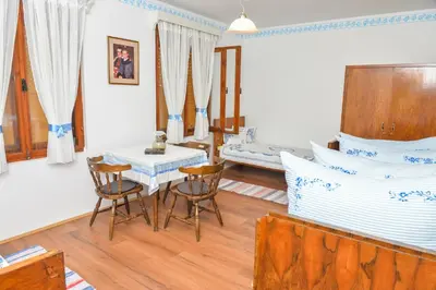 a bedroom with a bed and a table and chairs at etno dom 
