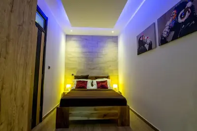 a bedroom with a bed with two pillows at Cosmopolitan Apartment in Belgrade