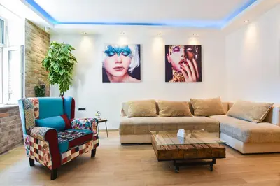 a living room with a couch and a table at Cosmopolitan Apartment in Belgrade