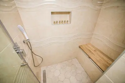a shower with a glass door and a shower at Cosmopolitan Apartment in Belgrade