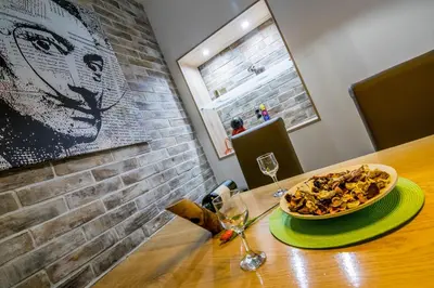 a wooden table with a bowl of food on it at Cosmopolitan Apartment in Belgrade