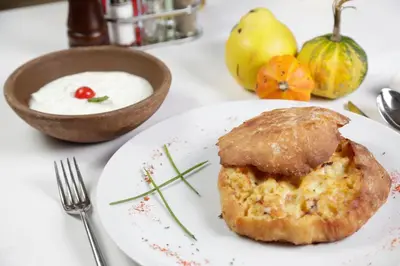 a white plate with a piece of food on a table at Accommodation Tara in Belgrade
