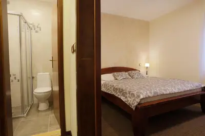 a bedroom with a bed and a bathroom with a toilet at Accommodation Tara in Belgrade
