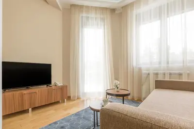 a living room with a couch and a flat screen tv at Prime Hotel Apartmani in Belgrade