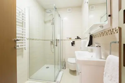 a bathroom with a shower and a toilet and a sink at Prime Hotel Apartmani in Belgrade