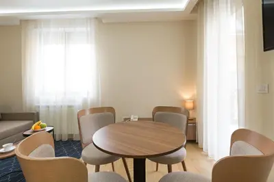 a dining room with a table and chairs at Prime Hotel Apartmani in Belgrade
