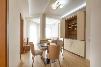 a kitchen and dining room with a table and chairs at Prime Hotel Apartmani in Belgrade