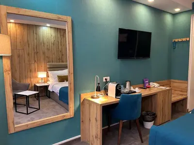 a room with a desk and a bed and a mirror at MARK Hotel in Belgrade