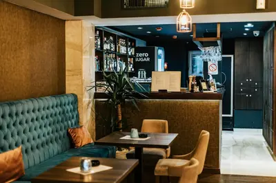 a restaurant with two tables and a bar at MARK Hotel in Belgrade